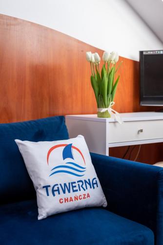 a blue couch with a white pillow on it at TAWERNA Chańcza in Chańcza