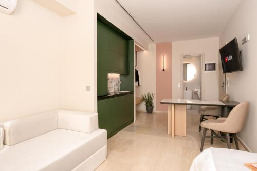 a bedroom with a green door and a desk in a room at Sea & the City in Thessaloniki