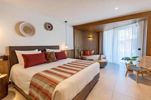 a bedroom with a large bed in a room at Minos Ambassador Suites & Spa - Adults only in Rethymno Town