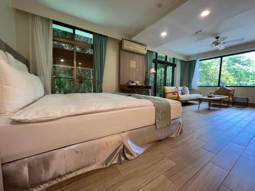 a bedroom with a large bed and a living room at Sea Passion Hotel in Koror