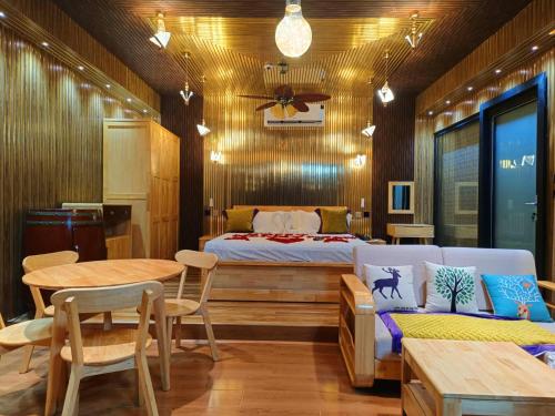 a bedroom with a bed and a table and chairs at Cola Goa Beach Resort in Cola