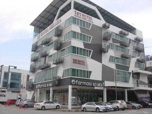 a building with cars parked in front of it at 707 Hotel Melaka (Orange) in Melaka