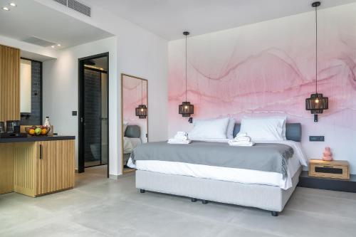 a bedroom with a large bed and a pink wall at SAVUS Boutique Hotel in Rethymno Town