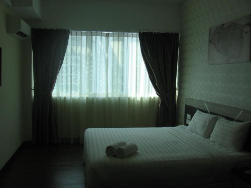 a hotel room with a bed and a window at 707 Hotel Melaka (Orange) in Melaka