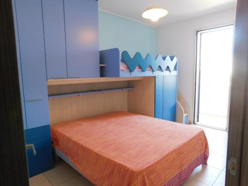 トッレ・サン・ジョヴァンニ・ウジェントにあるActon Apartment Torre San Giovanni - Verso Sudの青い部屋のベッド1台が備わるベッドルーム1室を利用します。