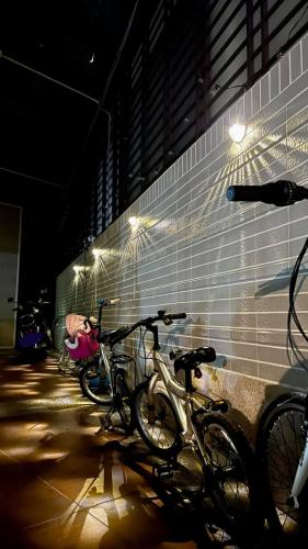 a group of bikes parked against a wall with lights at Dou Dou Long Homestay in Donggang