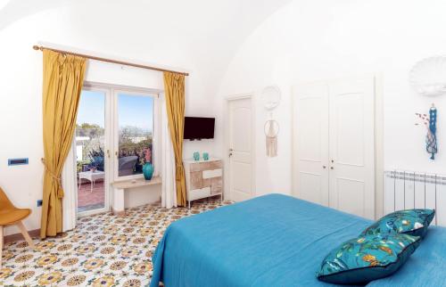 a bed room with a blue bedspread and blue walls at B&B Il Sogno in Anacapri