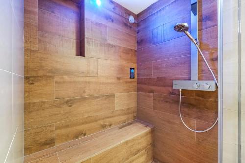 a bathroom with a shower with wooden walls at 170M2 Appartment with Jacuzzi & Steam bath in center of Amsterdam in Amsterdam