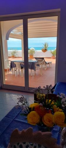 a room with a table and a view of the ocean at Casa Vacanze Elianto in Anzio
