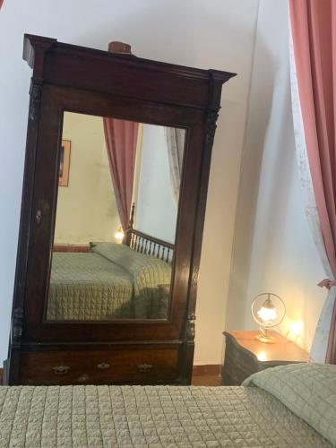 a bedroom with a large mirror and a bed at La dimora di Adelaide in Maratea