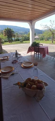 a table with a plate of food on top of it at Quinta da Ribeirinha in Arouca
