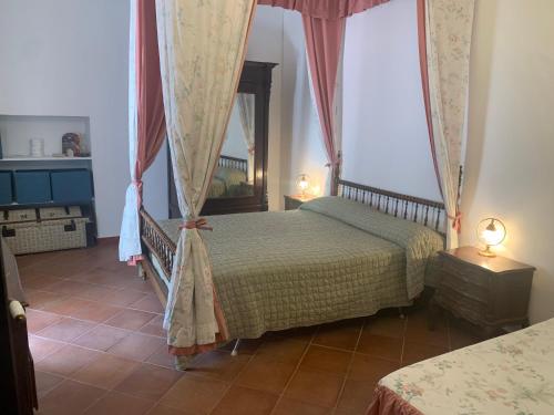 a bedroom with two beds and two lamps at La dimora di Adelaide in Maratea