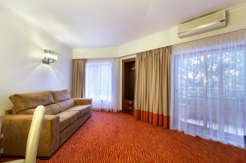 a living room with a couch and a large window at Avenida de Fatima in Fátima