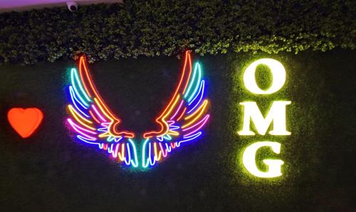 a neon sign with an eagle and the word love at Treebo Sky Point in Siliguri