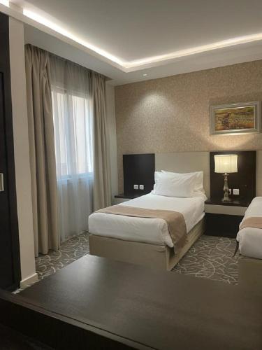 a hotel room with a bed and a window at شقق قولد ان للشقق المخدومة in Riyadh