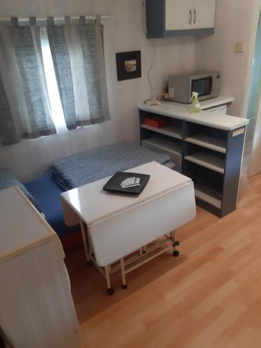 a room with a bed and a desk and a table at Ubytovanie v súkromí in Dolné Plachtince
