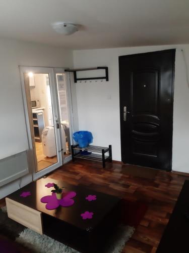 a living room with a table and a mirror at Ubytovanie v súkromí in Dolné Plachtince