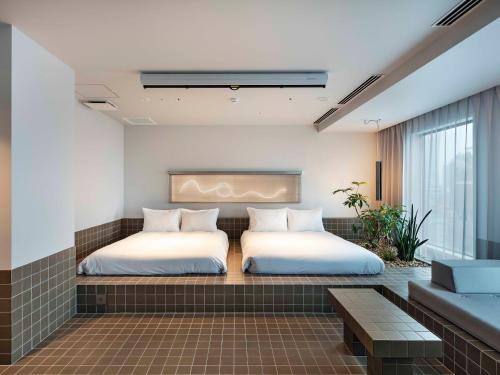 Кровать или кровати в номере all day place shibuya
