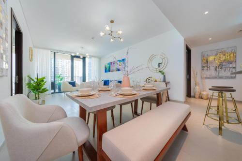 a living room with a dining room table and chairs at EDEN'S Homes & Villas - BLVD Heights in Dubai