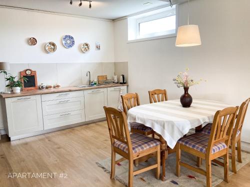 a kitchen with a table with a vase on it at Apartamenty 72 - Agroturystyka in Wola Pękoszewska