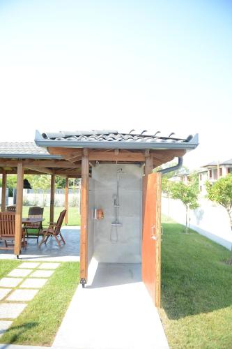 a shower under a gazebo in a yard at Luxury Villa Plaka Litochorou with Pool in Plaka Litochorou