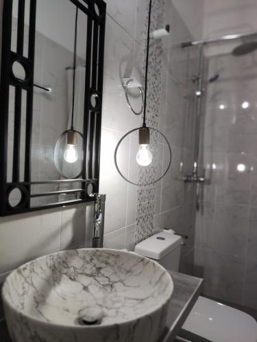 a bathroom with a large marble sink and a shower at Gioula's Residence in Patitiri
