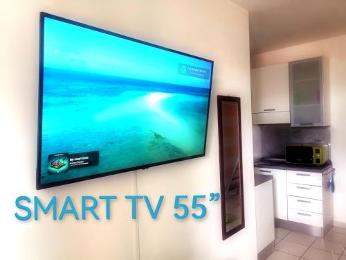 a flat screen tv hanging on a wall at ALBACHIARA INN Residence Apartments in Ameglia