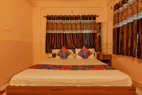 a bedroom with a bed with a window at FabHotel Yatika Residency in Kolkata
