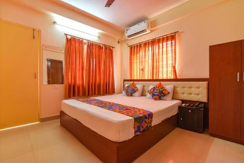 a bedroom with a large bed in a room at FabHotel Capital Casa in Kolkata