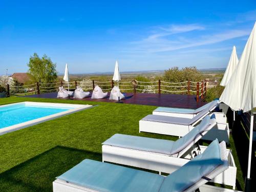 a pool with chaise lounge chairs and a swimming pool at Love and Dream Élményvilla in Zalakaros