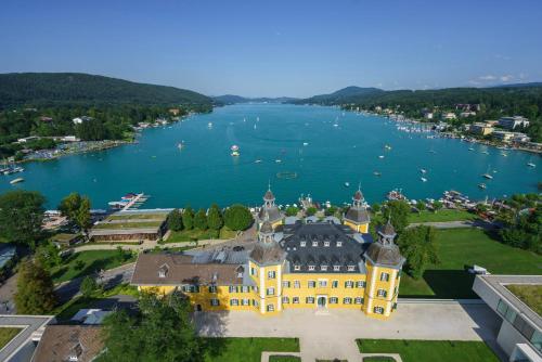 an aerial view of a building next to a body of water at Beutlich's Wörtherseeappartements in Velden am Wörthersee