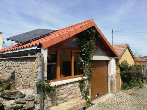 a house with solar panels on the roof at Casa Freixedelo in Santa Comba de Rossas