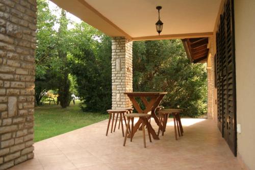a patio with a table and chairs on it at Mediterrán Villa Zamárdi in Zamárdi