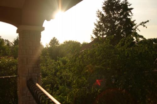 a view of the sun from the porch of a house at Mediterrán Villa Zamárdi in Zamárdi