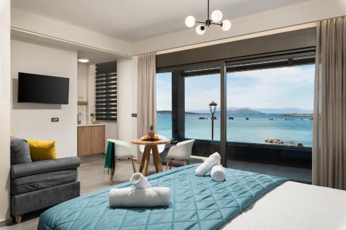 a bedroom with a bed and a view of the ocean at Archin Boutique suites in Chania