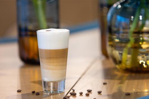 a glass of coffee sitting on top of a table at Hotel Indigo Cagnes-sur-Mer by IHG in Cagnes-sur-Mer
