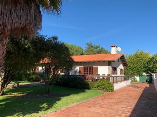 a house with a red roof and a brick driveway at A Quinta Duna in Salir de Porto