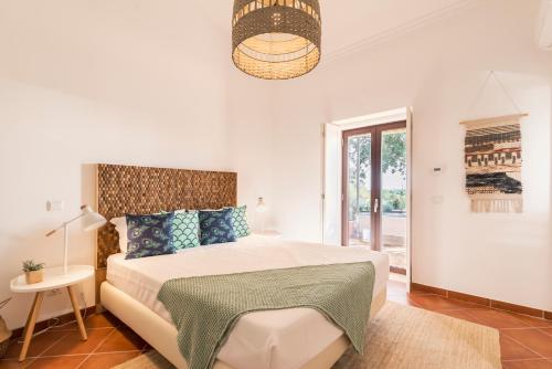 Ένα ή περισσότερα κρεβάτια σε δωμάτιο στο Quinta da Baleeira
