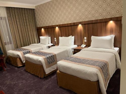 Ліжко або ліжка в номері Saraya Harmony Hotel C