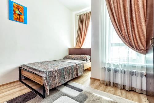 Postel nebo postele na pokoji v ubytování ЖК Expo Residence