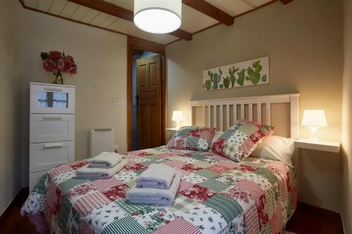 a bedroom with a bed with towels on it at La Nozaleda in Infiesto