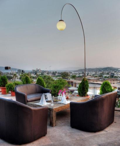 a patio with couches and a table on a roof at Lvzz Hotel in Bodrum City