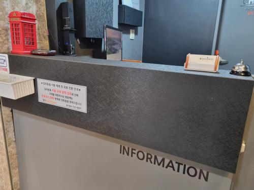 a counter in a store with ailitation sign on it at Charlie Hotel Jeju in Jeju