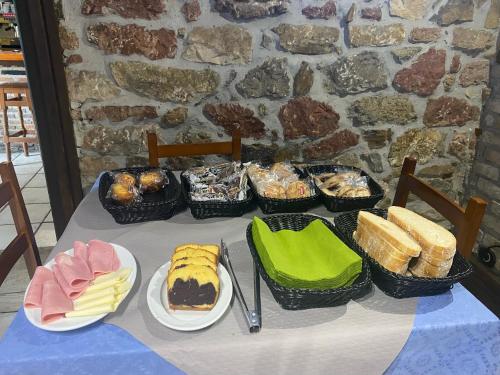 a table topped with baskets of food on top at Hotel Rural Los Texos in La Riera