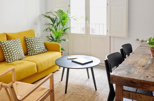 a living room filled with furniture and a table at Eco Boutique Hostal Grau in Barcelona