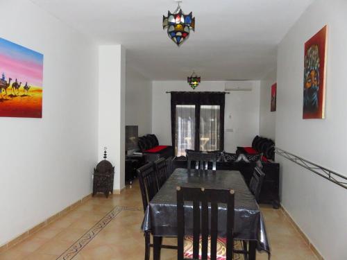 a dining room with a table and chairs at Chez Younès Appartement Marina Saidia Ap8 in Saidia 
