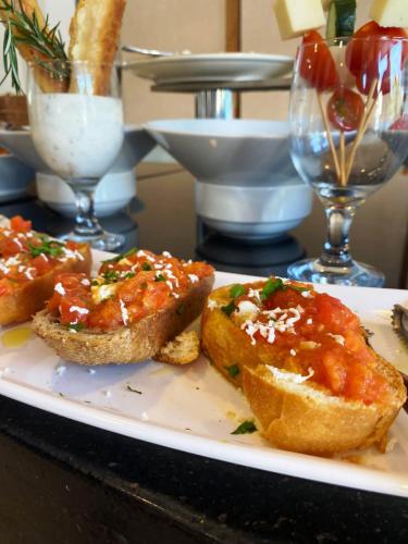 een bord met vlees en saus op een tafel bij Göcek Lykia Resort Premium Concept Hotel in Göcek