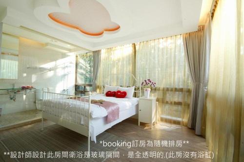a bedroom with a bed with red pillows on it at Full House Homestay in Yuchi