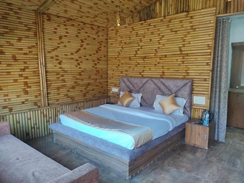 a bedroom with a bed in a wooden wall at HOA Resorts - Mountain View with Infinity Pool in Shivpuri