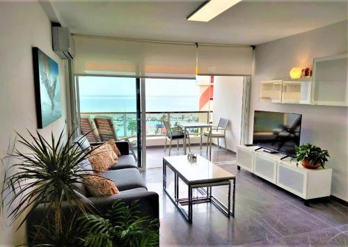 a living room with a couch and a table at Apto El Faro Puerto Deportivo in Marbella